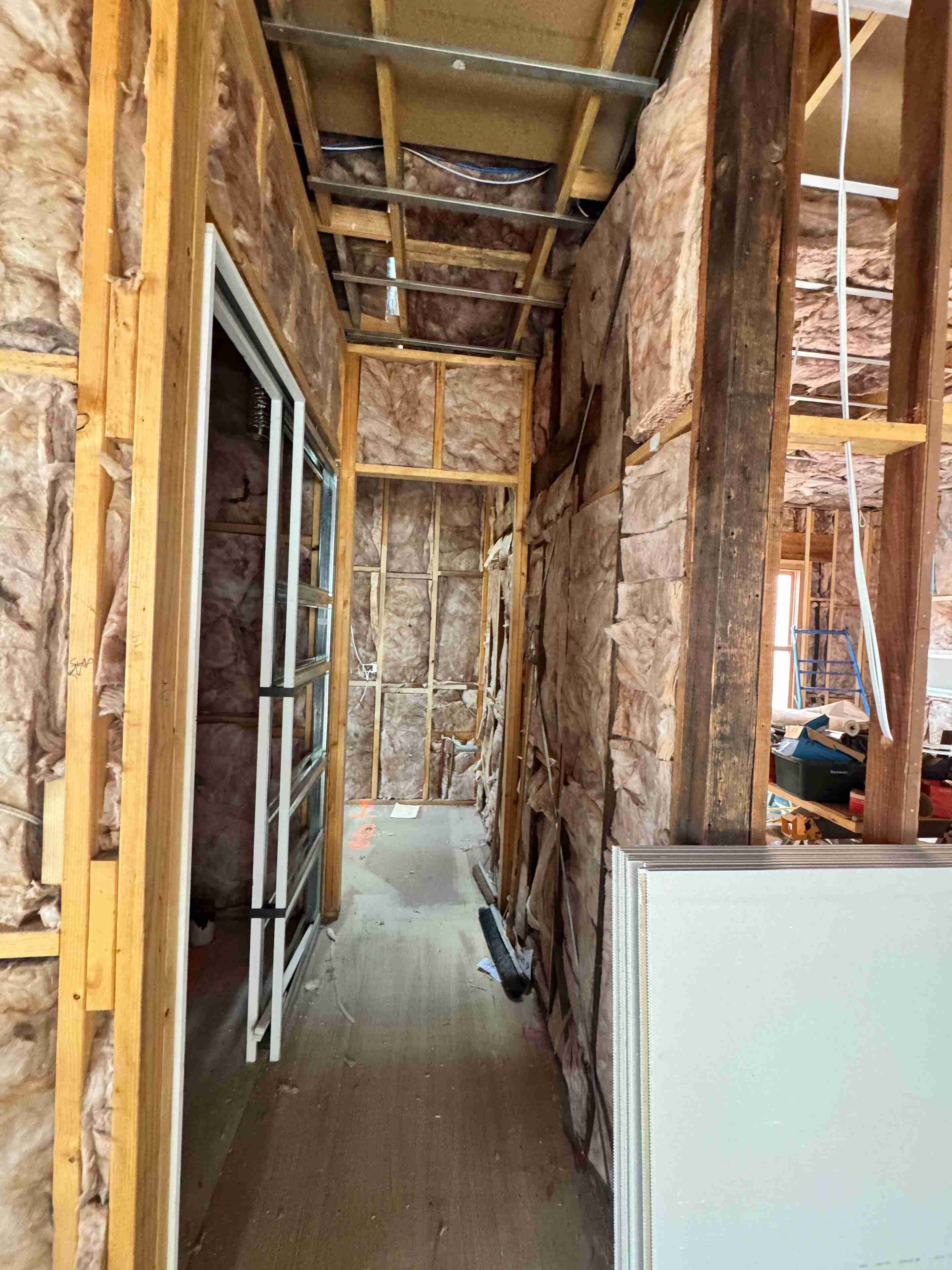 Insulation contractor assessing a residential property exterior